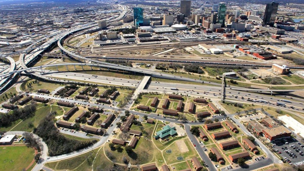 Looking almost like barracks, Butler Place is in the foreground of this west-facing aerial view of Interstate 35W, Interstate 30 and downtown Fort Worth in February 2014. The rail yard is between the interstate and downtown.