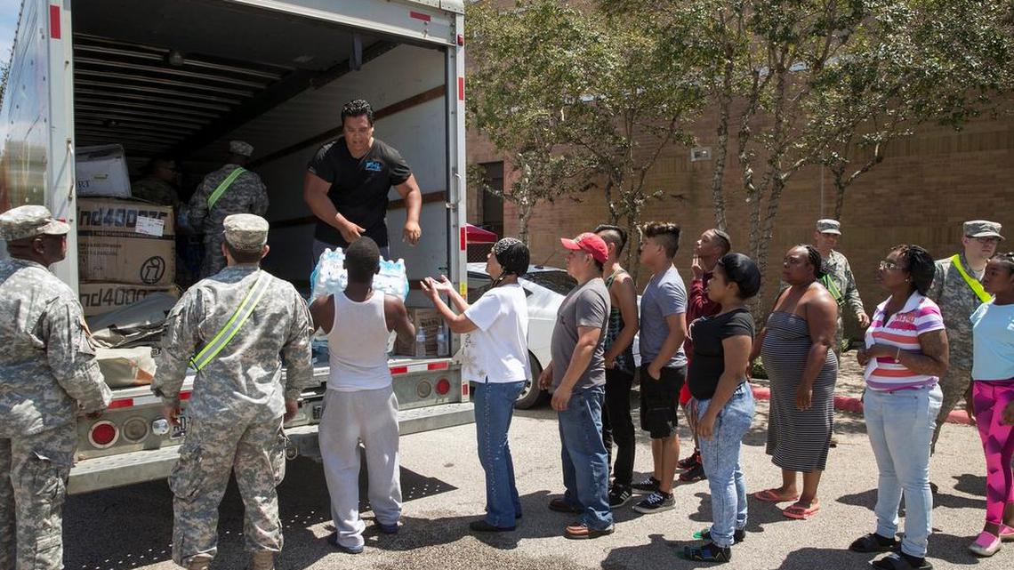 People line up for water at the Beaumont Civic Center after the city's main supply of water was lost after Hurricane Harvey on Thursday Aug. 31, in Beaumont. The city of about 120,000 people has been hit hard by flooding from Harvey, which came ashore last Friday as a Category 4 hurricane and hovered for days in the region.