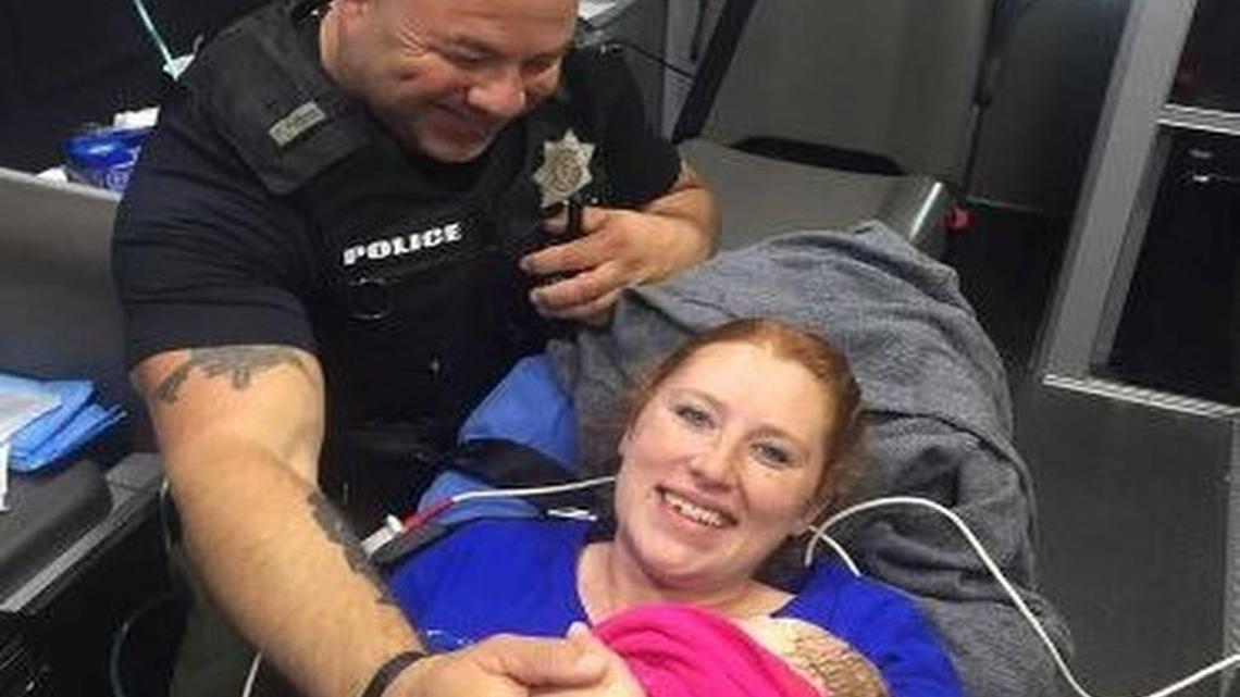 A picture of Deputy Constable Mark Diebold with Destiny Hall after he helped deliver her baby was seen worldwide.