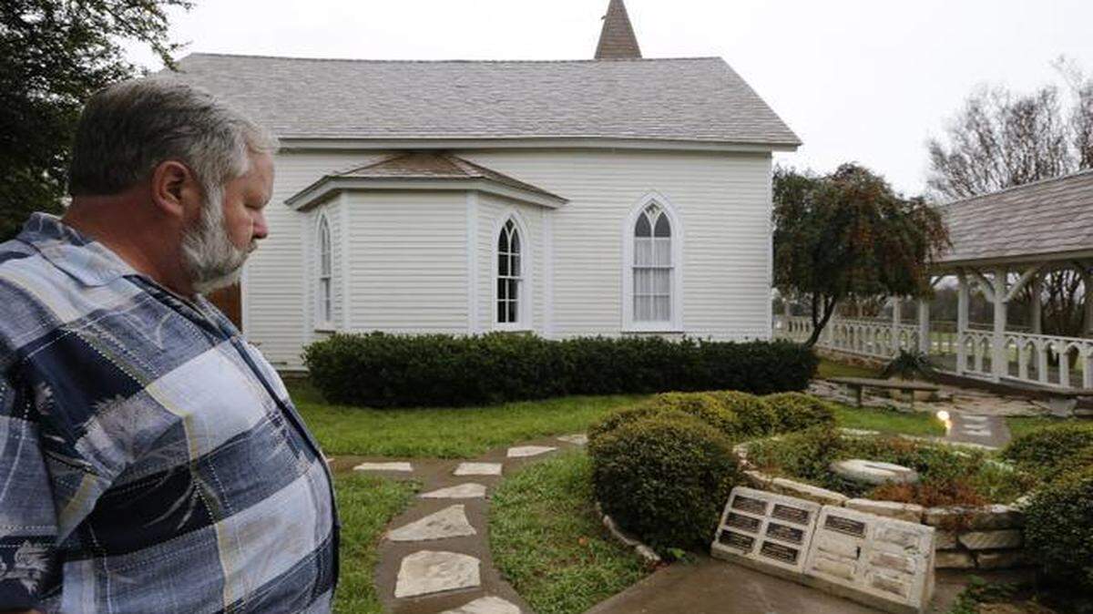 
Church member Devan Breedlove looks over the courtyard where plaques were stolen and a statue of Jesus was vandalized this week at The Church of Christ the King & All Saints in west Fort Worth. 

