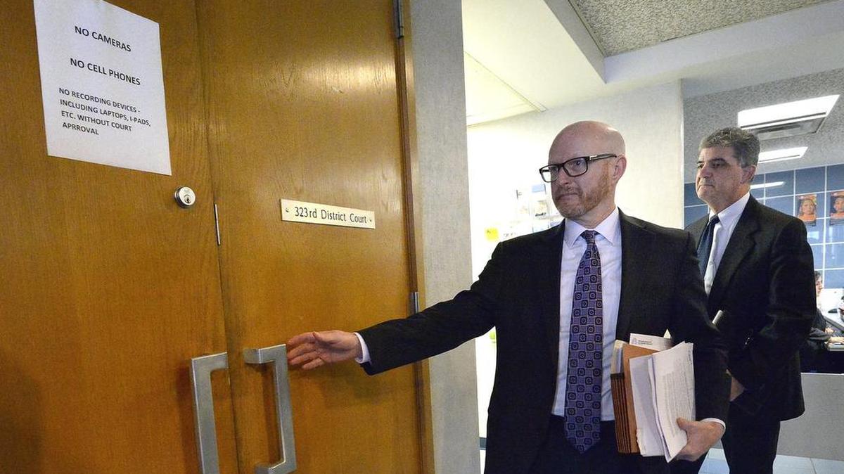 Riley Shaw, left, enters a courtroom in 2016 when he was a Tarrant County prosecutor.