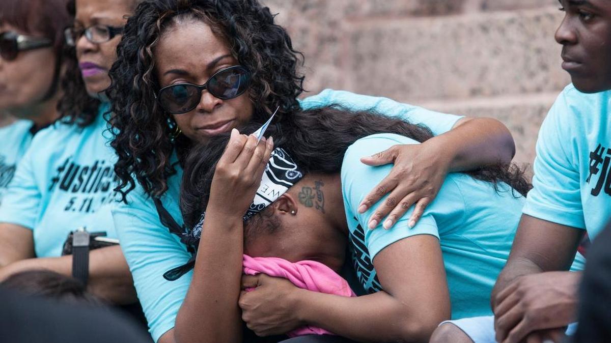 Maurisa Goldston, right, is comforted by a family friend after an anti-police brutality march in Fort Worth on May 30, 2015. Her brother, Kelvin Goldston, was fatally shot by a Fort Worth police officer on May 11, 2015.