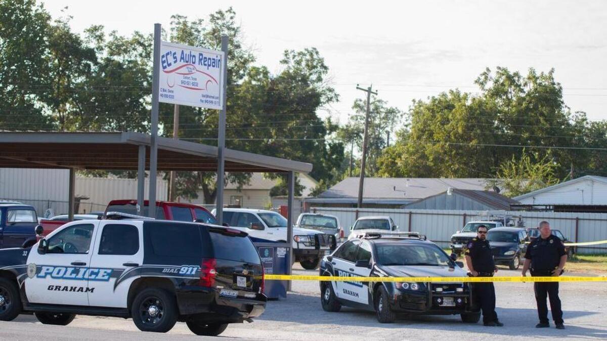 
Graham police officers stand outside EC’s Auto Repair while Texas Rangers and Graham investigators gather evidence in the Leah Martin case.
