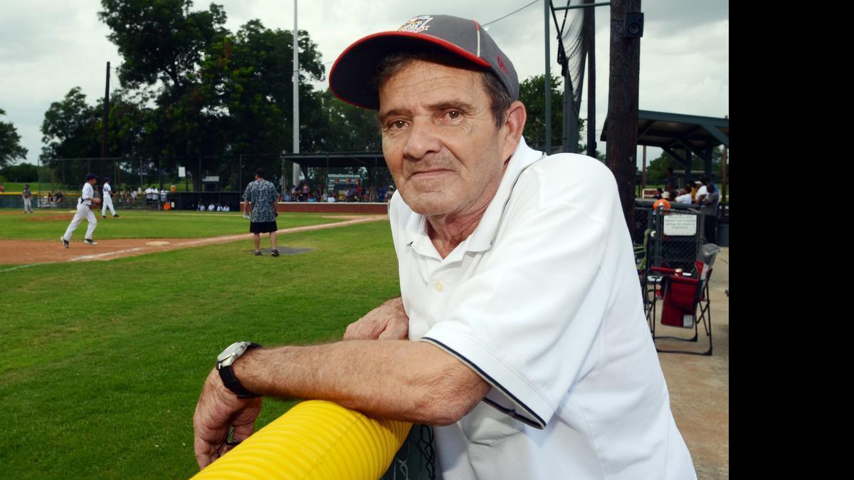 
Charles Buckner, longtime District 7 Little League administrator, stands at the fence as a 9-10 year-old game is played at Kelly Park in Fort Worth on June 26. Buckner is retiring from his voluntary post.
