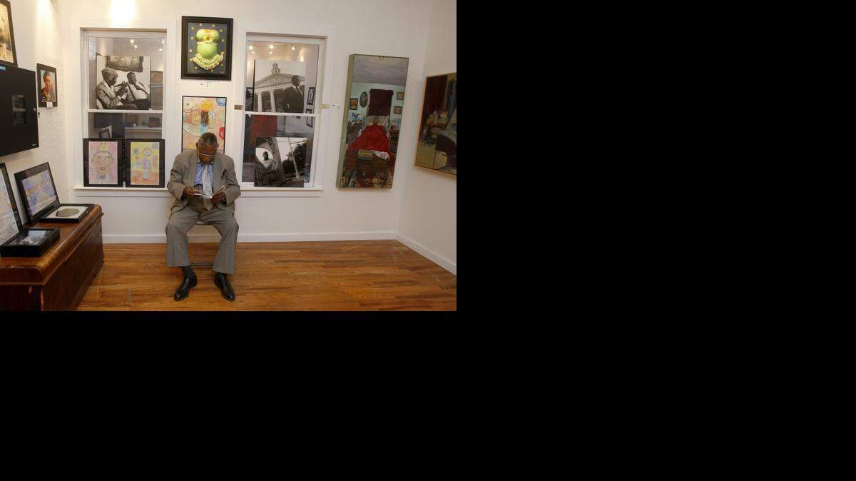 
Clifford Davis of Fort Worth looks through the program of a juried art show at the Lenora Rolla Heritage Center Museum in Fort Worth on Thursday.
