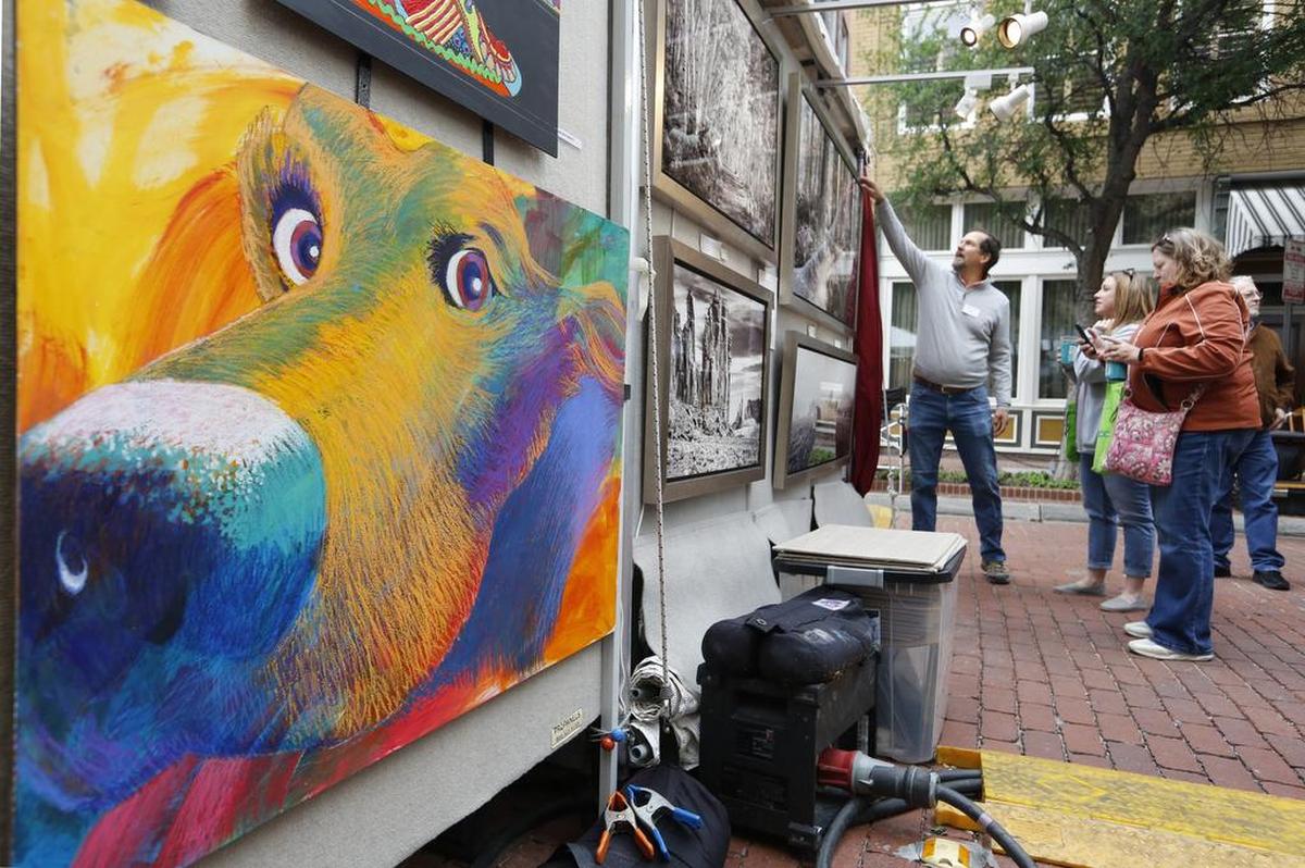Visitors to the Main Street Fort Worth Arts Festival admire artwork on Saturday April 22, 2017.
