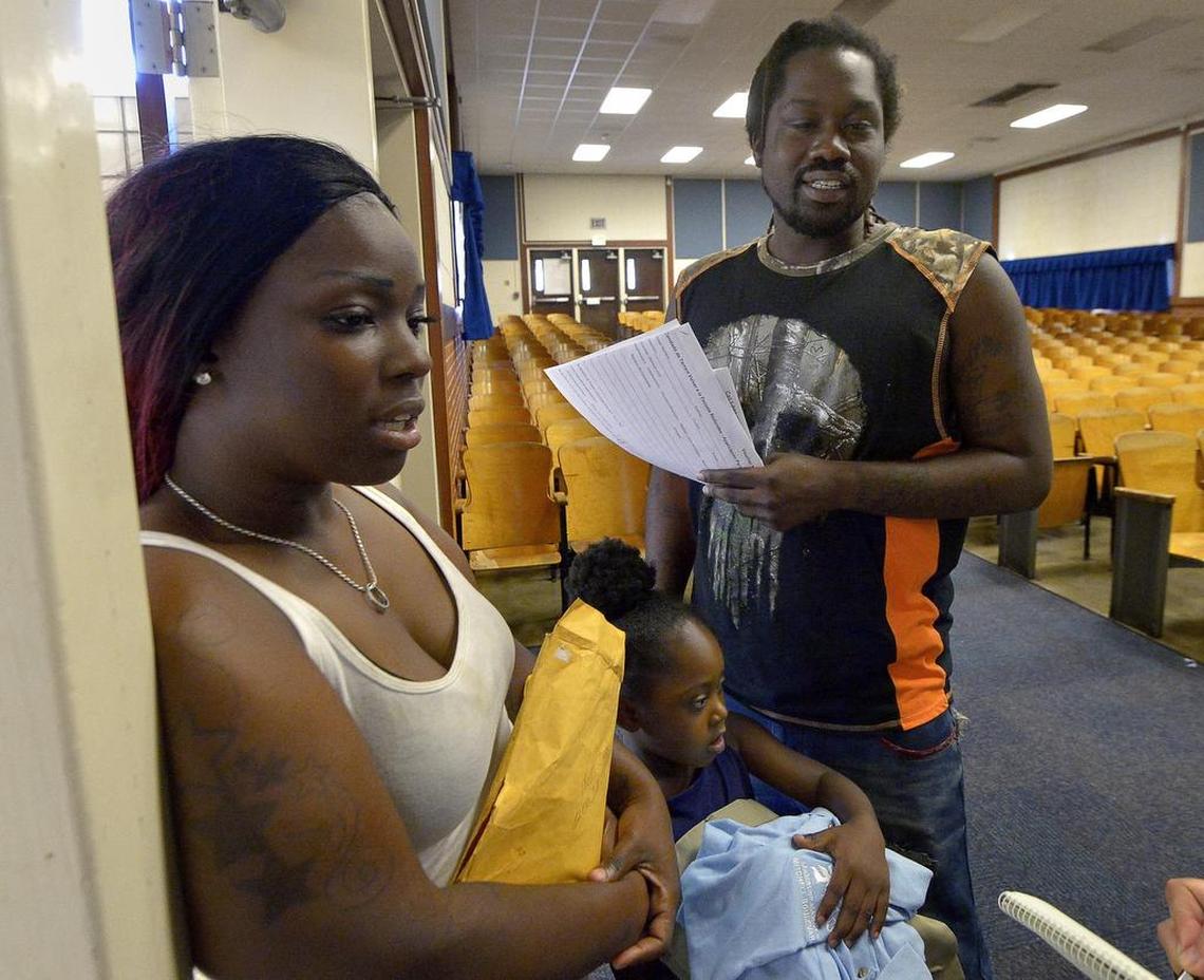 Shaniquia Johnson and Ronald Davis picked up their children's uniforms at Leadership Academy at Mitchell Boulevard earlier this month. The parents hope their school can become a better school.