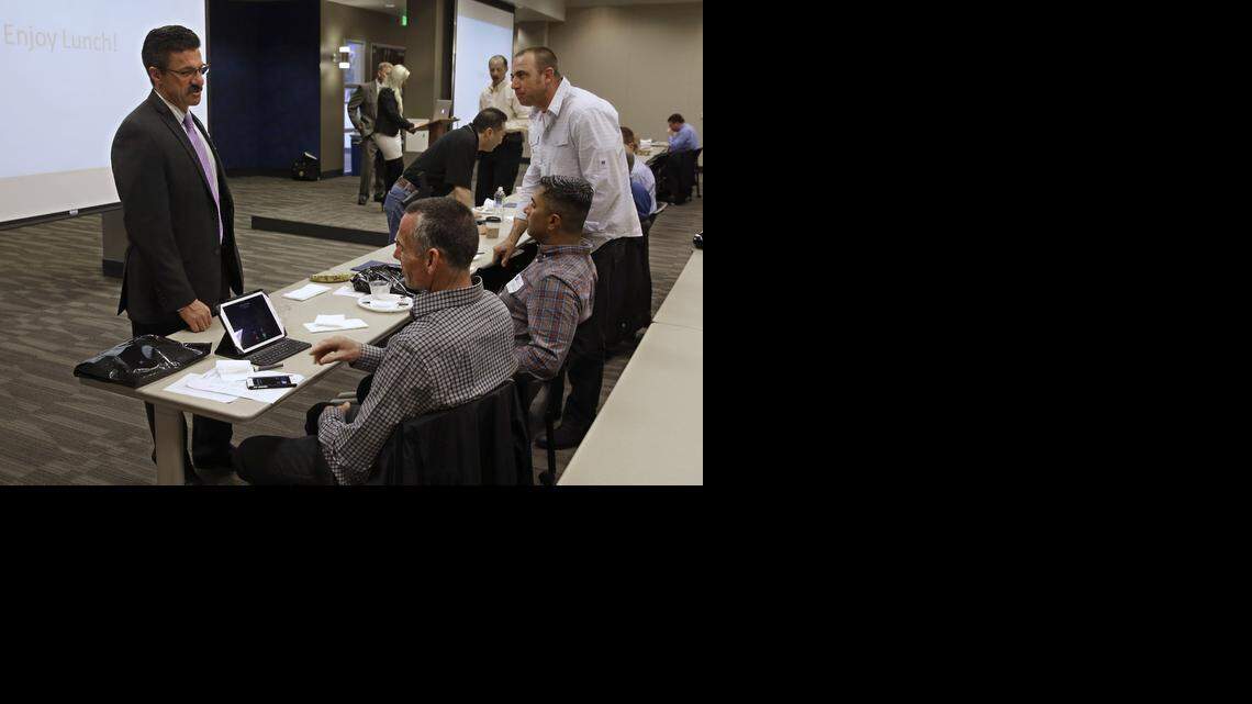 
Retired Fort Worth Police Chief Jeffery Halstead, left, talks with attendees at a conference on the use of body cameras hosted by Taser International for law enforcement personal at the California Highway Patrol headquarters in Sacramento, Calif., on Feb. 19. Halstead successfully pushed the city of Fort Worth to approve a no-bid contract worth up to $2.7 million to purchase body cameras from Taser, the stun gun maker that is now a leading supplier of body cameras for police.
