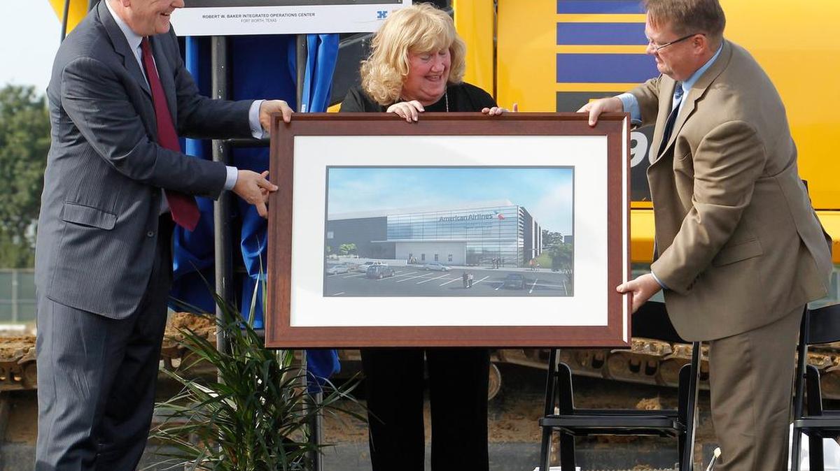 American Airlines chairman and CEO Doug Parker, Marty Baker, widow of Robert W. Baker, and their son Robert Baker, Jr., with a rendering at the ground-breaking in 2014 of the Integrated Operations Center. The project received incentives from Fort Worth. The city is considering changes to its abatement policies.