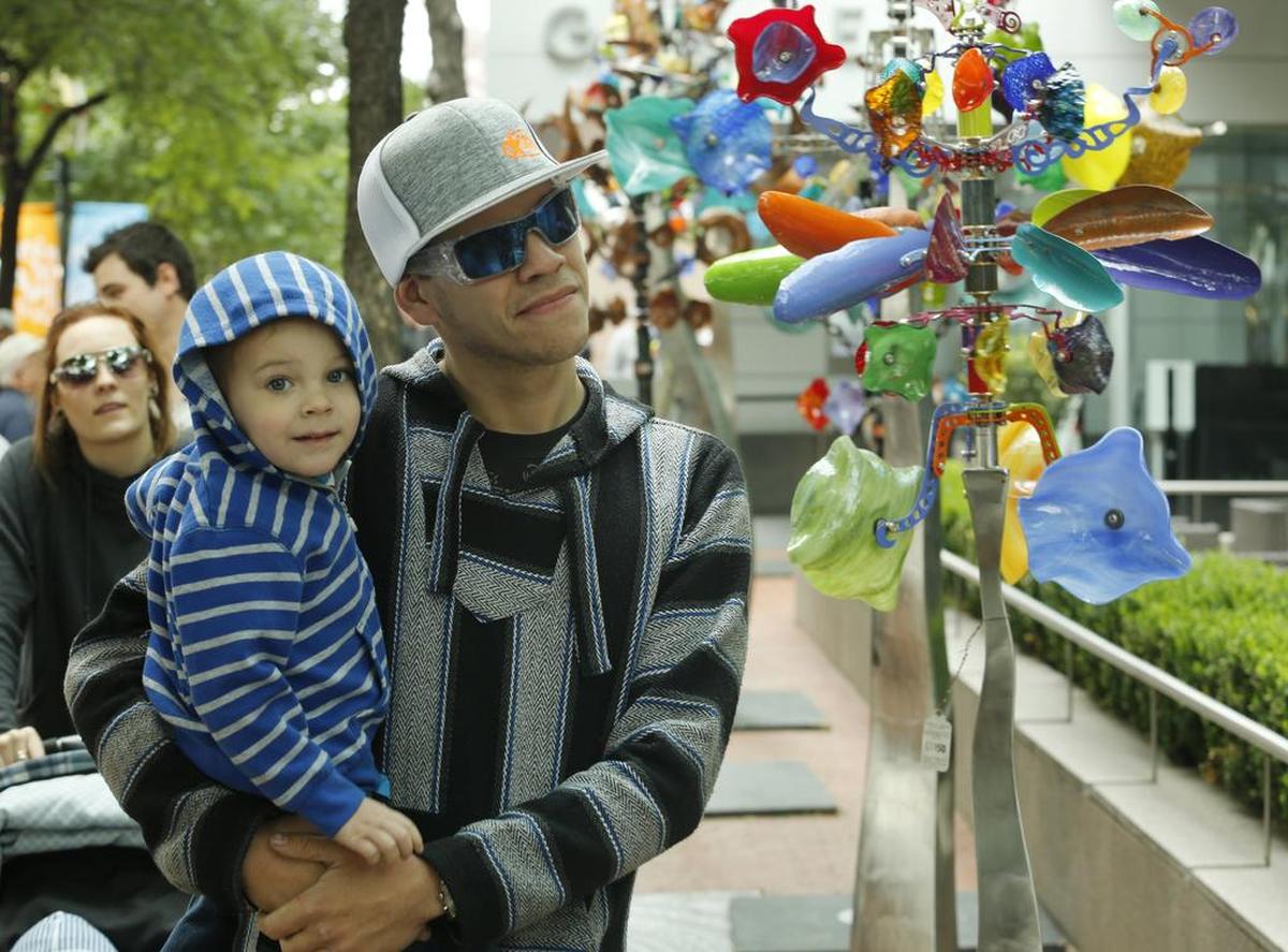 Zak Schmidt of White Settlement admires artwork with his son Easton, 3, at the Main Street Fort Worth Arts Festival in 2017.