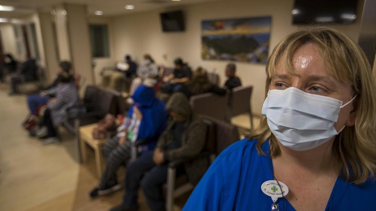Flu cases aren’t just raging in Tarrant County. Stephanie Scott, RN and charge nurse, keeps an eye on patients in the emergency department at St. Joseph's Hospital in Orange, Calif., on Friday.