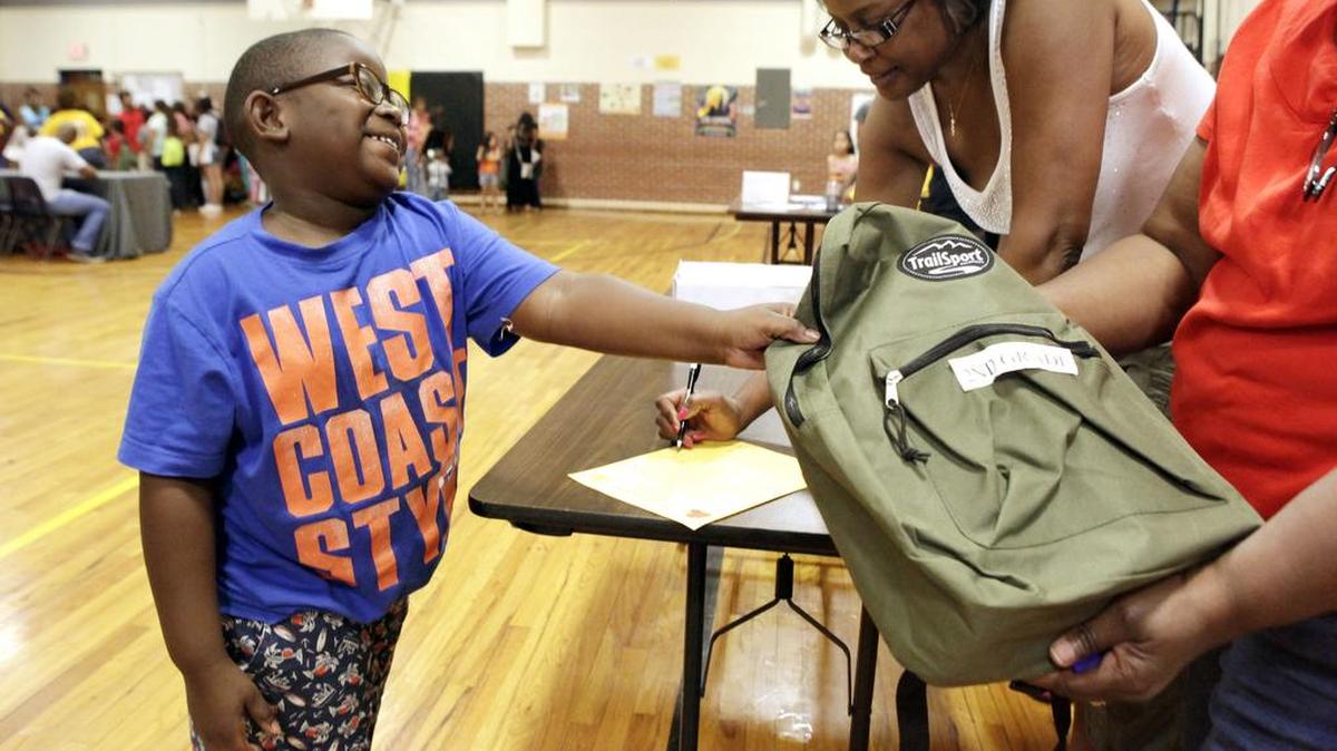 
Cortland Miller, 7, takes a second-grade backpack Saturday at Como Montessori School in Fort Worth. The school held its eighth annual back-to school giveaway. Kids were provided with over 550 backpacks, hair cuts and assistance with uniforms. 
