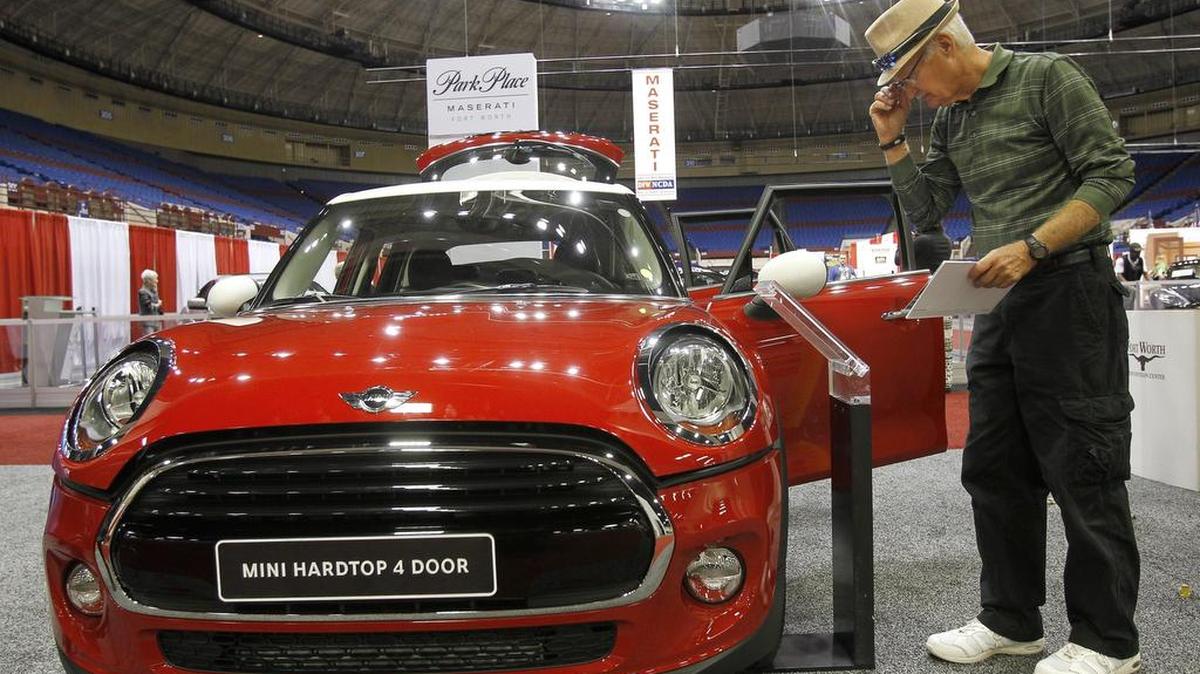 Roger Hendrickson of Granbury and a 2016 Mini Cooper hardtop at the DFW Auto Show at the Fort Worth Convention Center in downtown Fort Worth on Thursday.