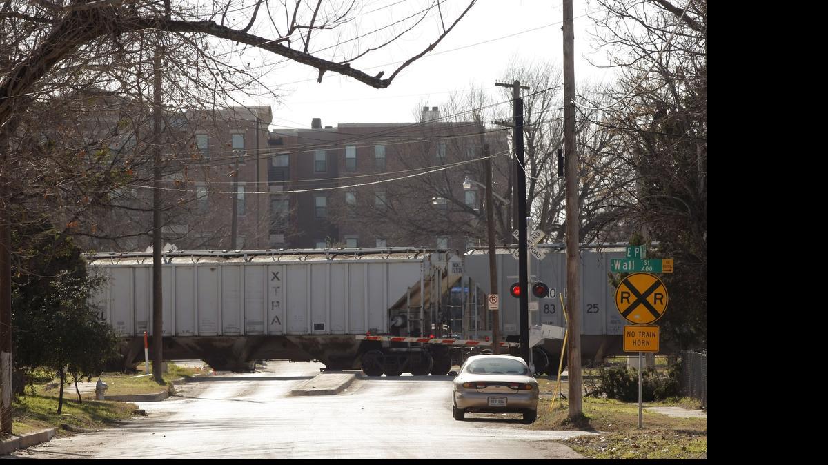 
 Train cars at intersection near downtown Fort Worth
