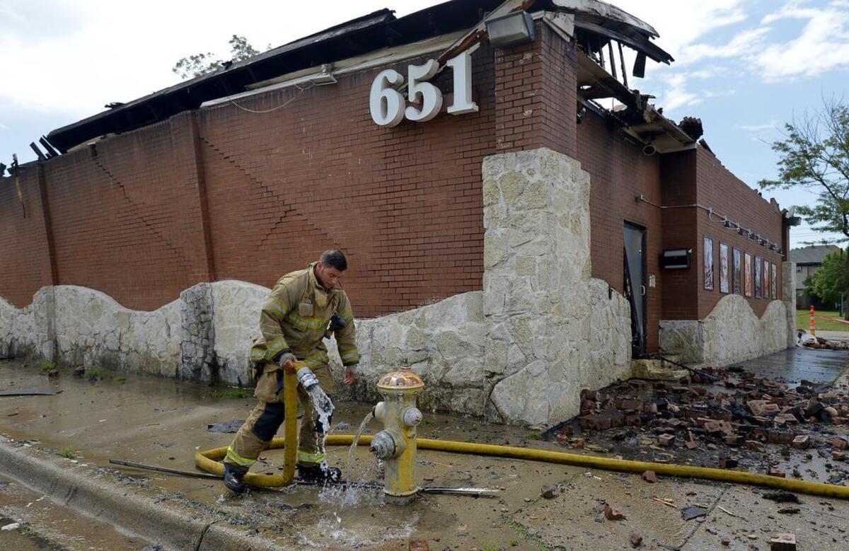 Fort Worth Firemen keep an eye on the Rainbow Lounge after an early morning fire destroyed the building on Thursday.