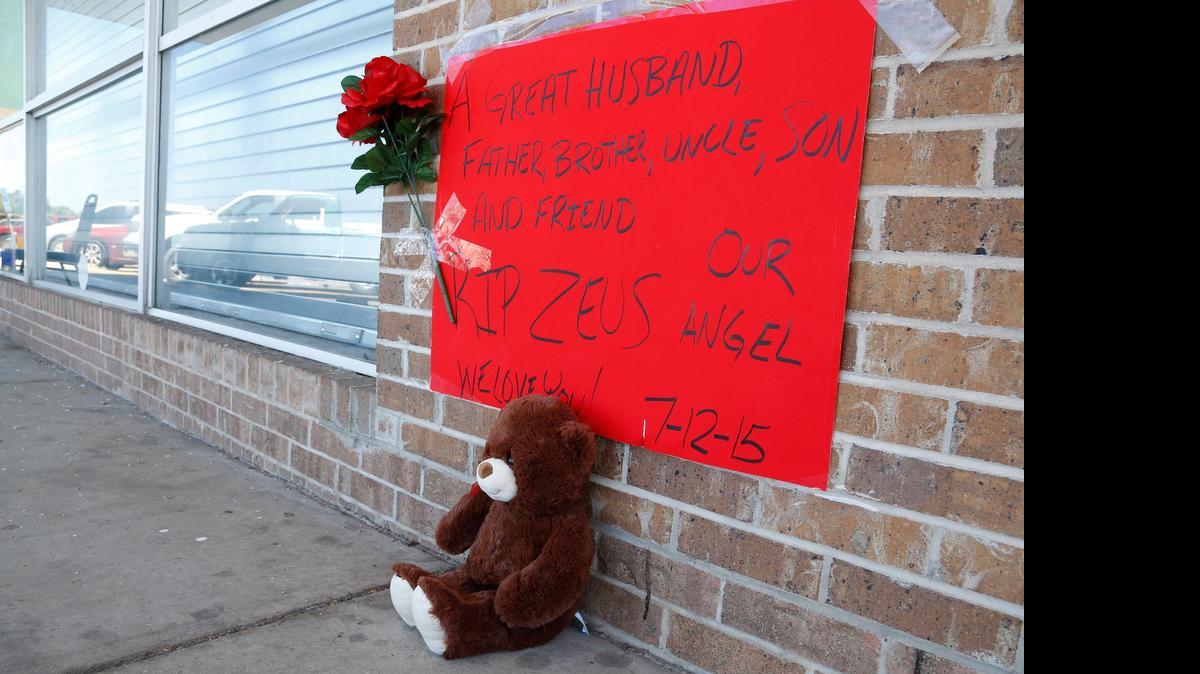 
A teddy bear sits outside a Liquorville store where a 26-year-old man was killed early Sunday when a gunman opened fire.
