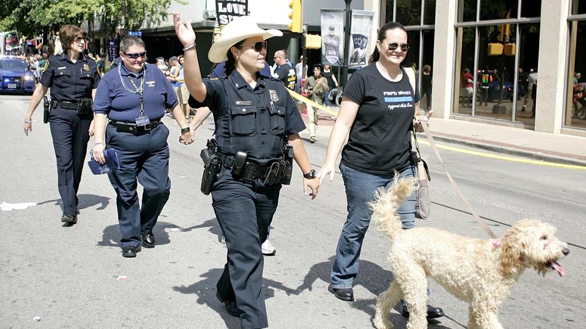 
Fort Worth police officers marched as acting Police Chief Rhonda Robertson brings up the rear during the Fort Worth Gay Pride Parade down Houston Street on Saturday afternoon. Groups, corporations and individuals marched in hopes of highlighting the diversity of the city. 
