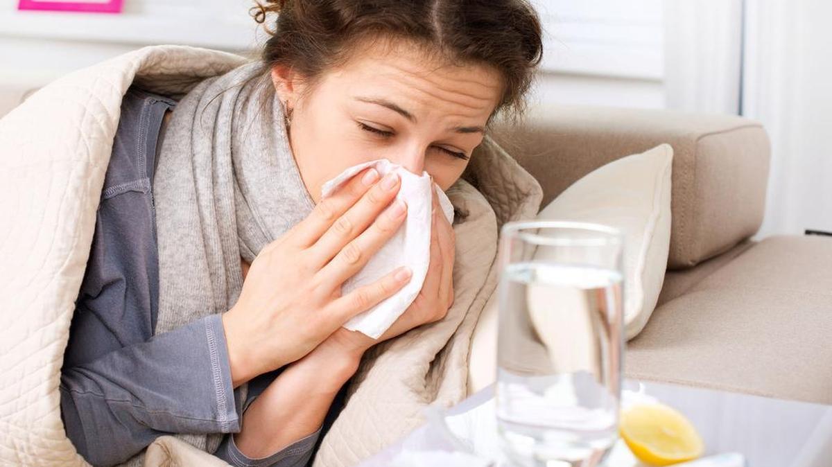 A stock image of a woman with the flu.