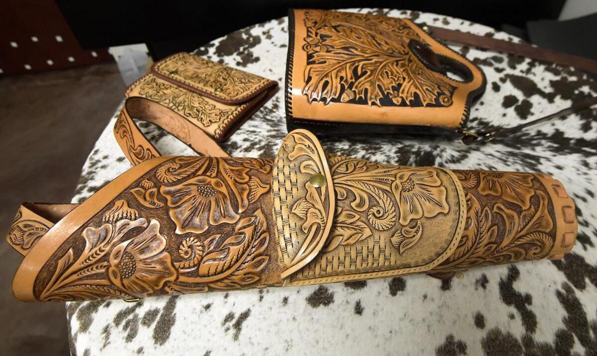 A leather arrow quiver, hand bag and purse are examples of the work that George Hurst did at Tandy Leather.