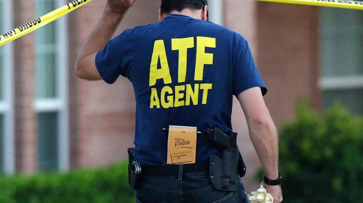 An ATF agent lifts crime scene tape in 2013 in DeSoto.