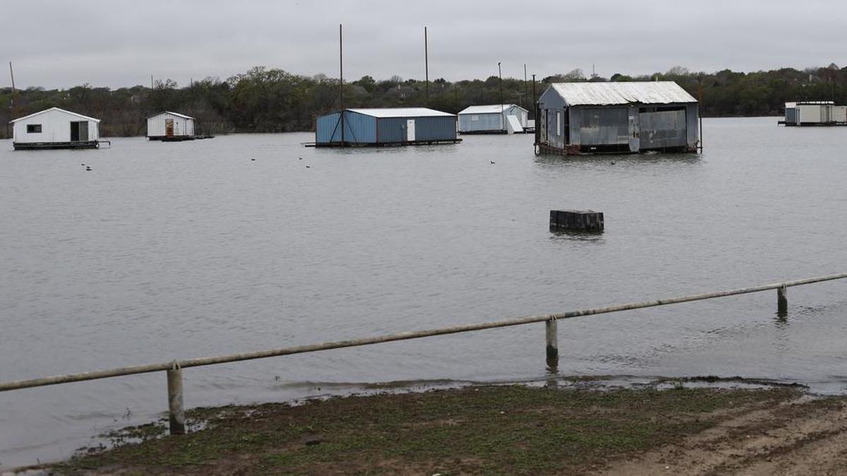 Boat houses are surrounded by water as lake levels have gotten higher at Lake Grapevine.