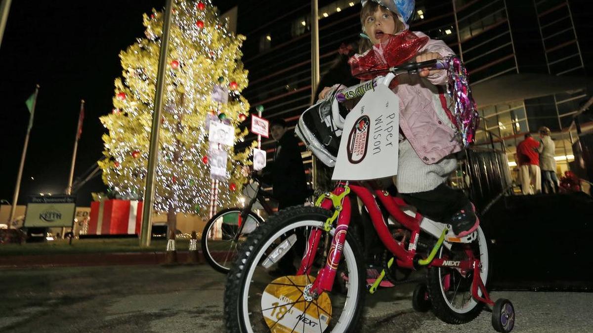 Piper Wilson, 6, on her new bike, pedals past the giant Christmas tree at Texas Motor Speedway, Tuesday, Dec. 1, 2015.