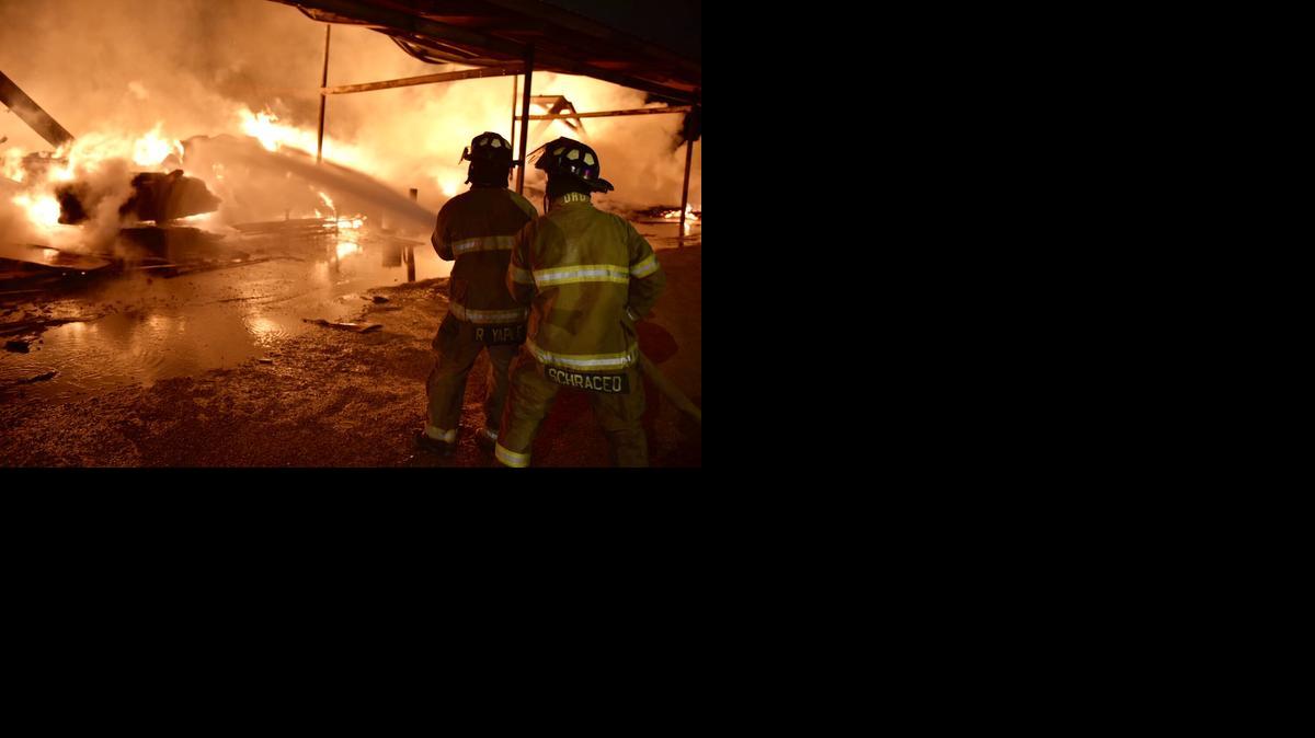 
Fort Worth firefighters work at a commercial building fire at 2508 E. Lancaster Ave early Saturday. 
