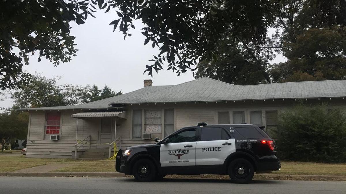 A Fort Worth police SUV remains outside a home in the 1700 block of Fairmount Avenue Friday, one day after a 32-year-old woman was found dead inside.