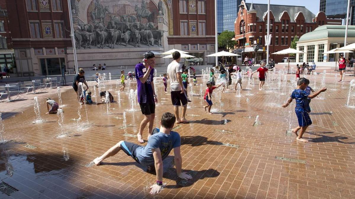People cool off in the fountains in Sundance Square. Heatstroke and heat exhaustion, which are responsible for more than 600 deaths a year, can be prevented by taking smart precautions this summer.