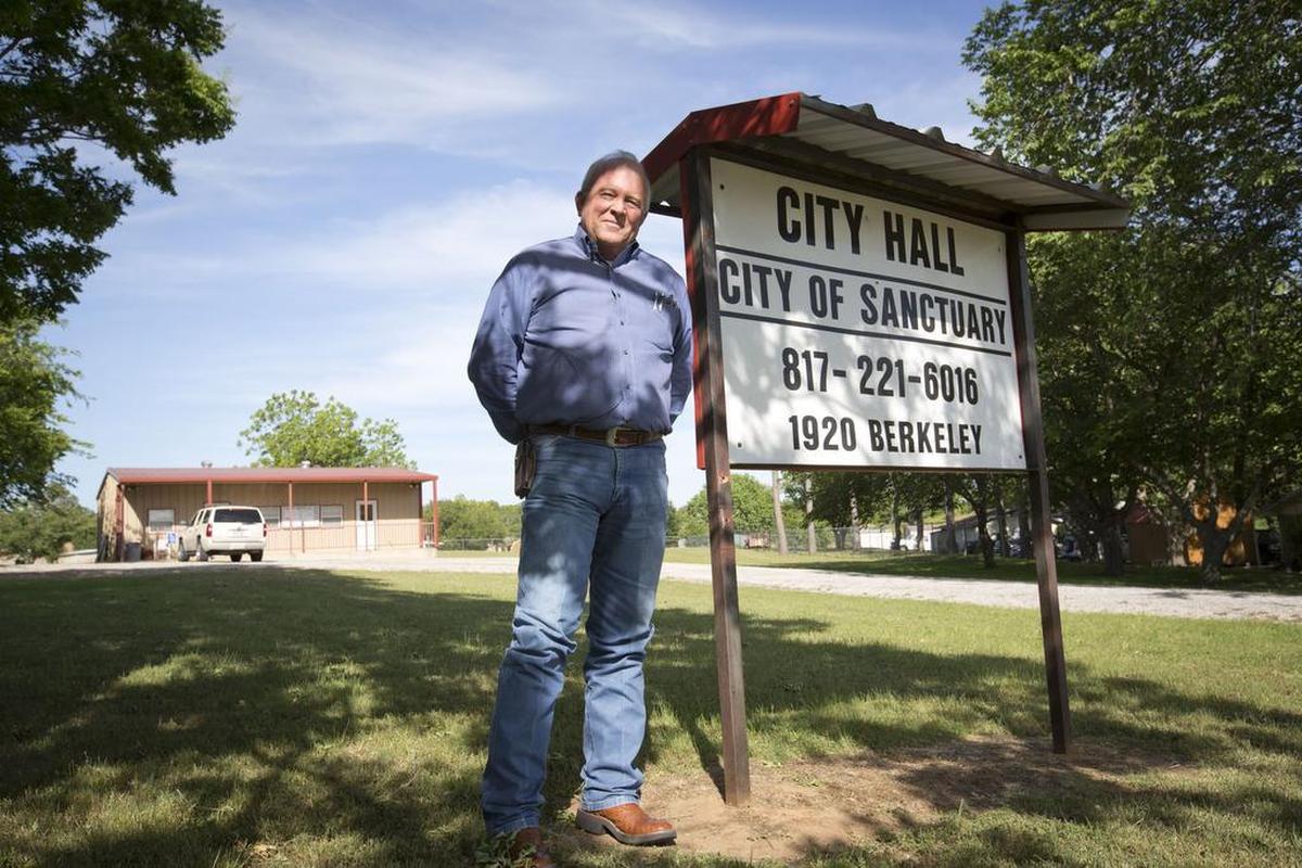 The mayor of Sanctuary, Cliff Scallan, in front of Sanctuary’s city hall.