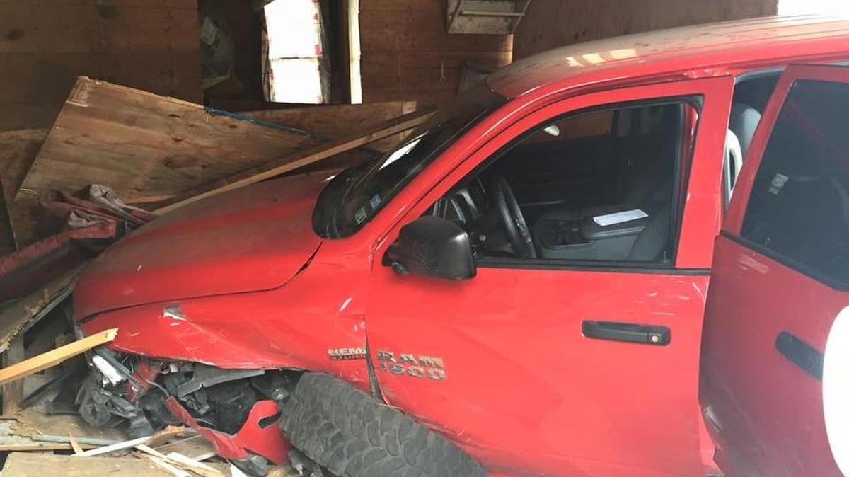 A pickup truck crashed into three cars in the 1700 block of South Adams Street in Fairmount Sunday before slamming through the front of a house, neighbors said.