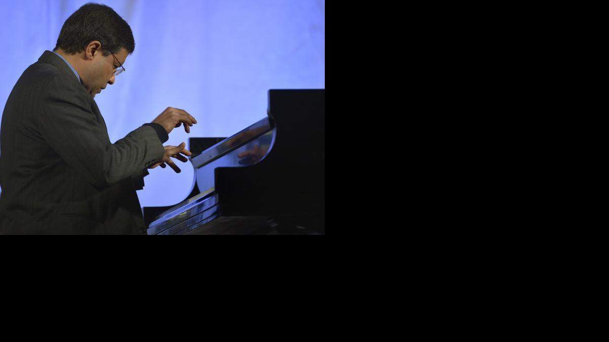 
Jose Feghali, 1985 Cliburn gold medalist, plays at the Van Cliburn Memorial Concert at Sundance Square Plaza in Fort Worth onFeb. 27, 2014. 
