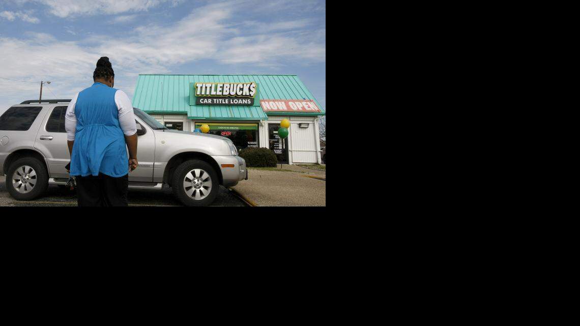 
Mary Dixon, who requested that her face not be shown, stands beside her car, which she stands to lose if she can’t repay a car title loan.
