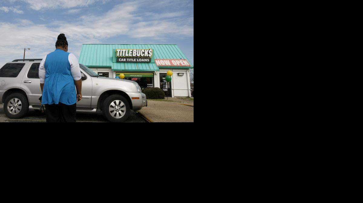 
Mary Dixon, who requested that her face not be shown, stands beside her car, which she stands to lose if she can’t repay a car title loan.
