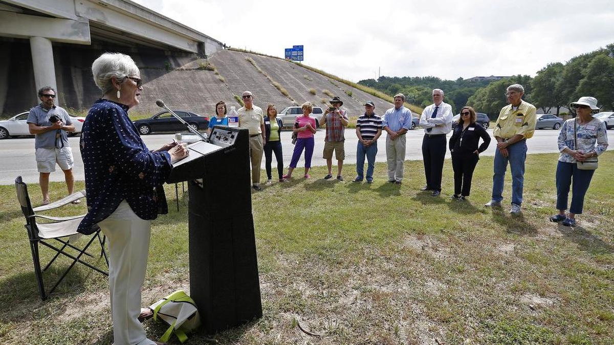 Carol Guarnieri, leader of the Stop the Bridge Coalition, talks to those gathered for a press conference near the Clear Fork of the Trinity River.