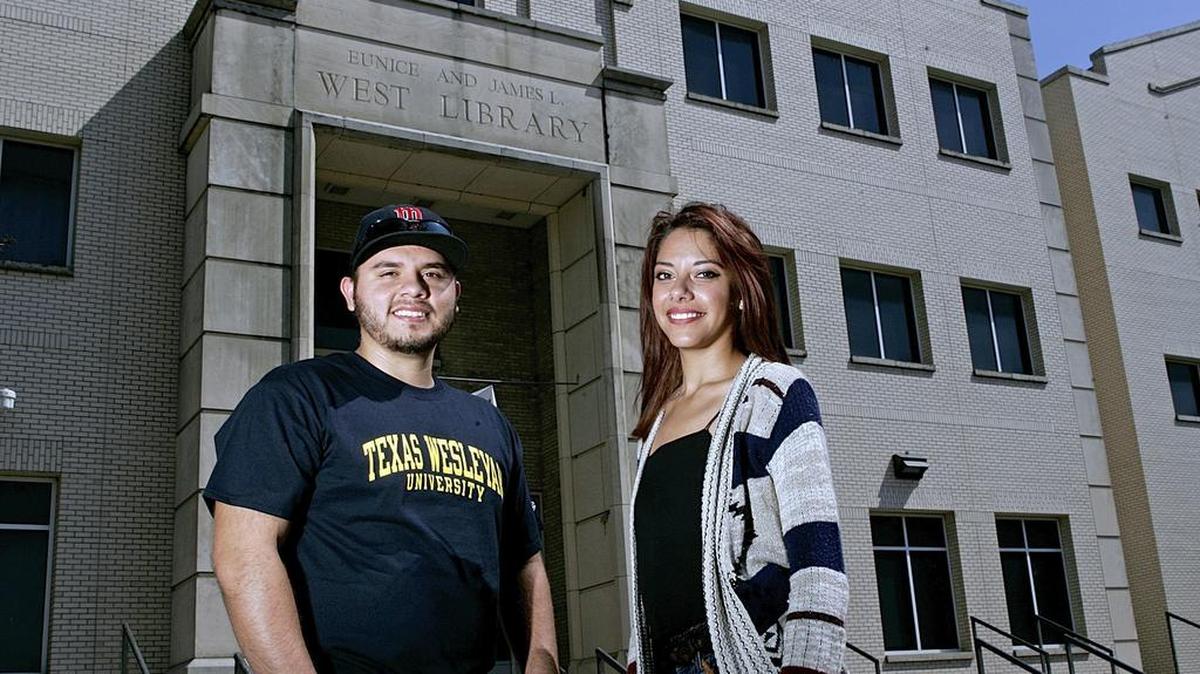 
Texas Wesleyan University sophomore Cesar Martinez and junior Jessica Diaz, at the campus’s West Library, graduated from Polytechnic High School and decided to stay home for college.
