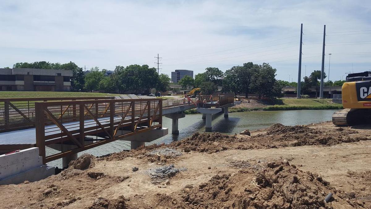 Pedestrian bridge connecting to the Trinity Trails near Mistletoe Heights awaits the last structural steel span.