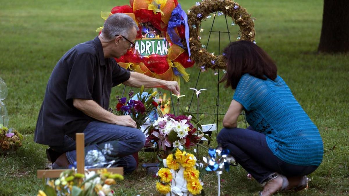
John Winkler and Laura Martinez tend to the grave site of Adrian Langlais. Winkler and Martinez frequently cared for the child, who died of suspicious injuries March 19, and have said Child Protective Services should have done more to protect Adrian.
