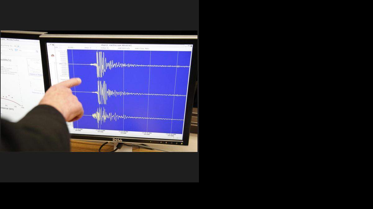 SMU professor Brian Stump points to seismograms on a screen from Irving station, deployed yesterday during a press conference at SMU on Jan. 6, 2015.