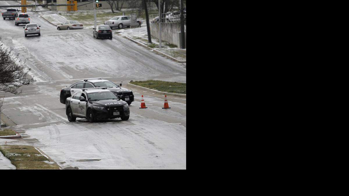 
Police close a portion of an ice-covered Summit Avenue Tuesday morning, awaiting a sand truck.
