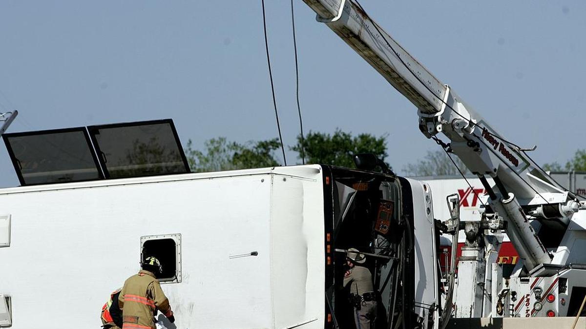 A Texas DPS trooper looks through the windshield of a bus bound for an Oklahoma casino that crashed on George Bush Turnpike in Irving Thursday, April 11, 2013.