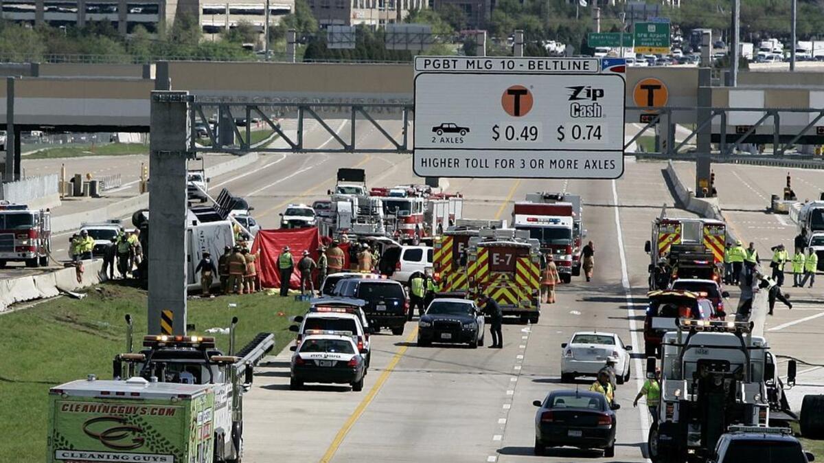 Emergency workers remove one of the deceased women from the charter bus crash on Texas 161 April 11, 2013 in this Star-Telegram archive photo.