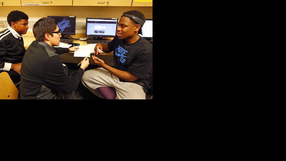 
Trimble Tech students Dontae Woods, 16, (left) and Damon Miller, 16, (right) are tutored by Paschal student Mario Garcia, 18, (center) as part of TCU's Upward Bound Program.

