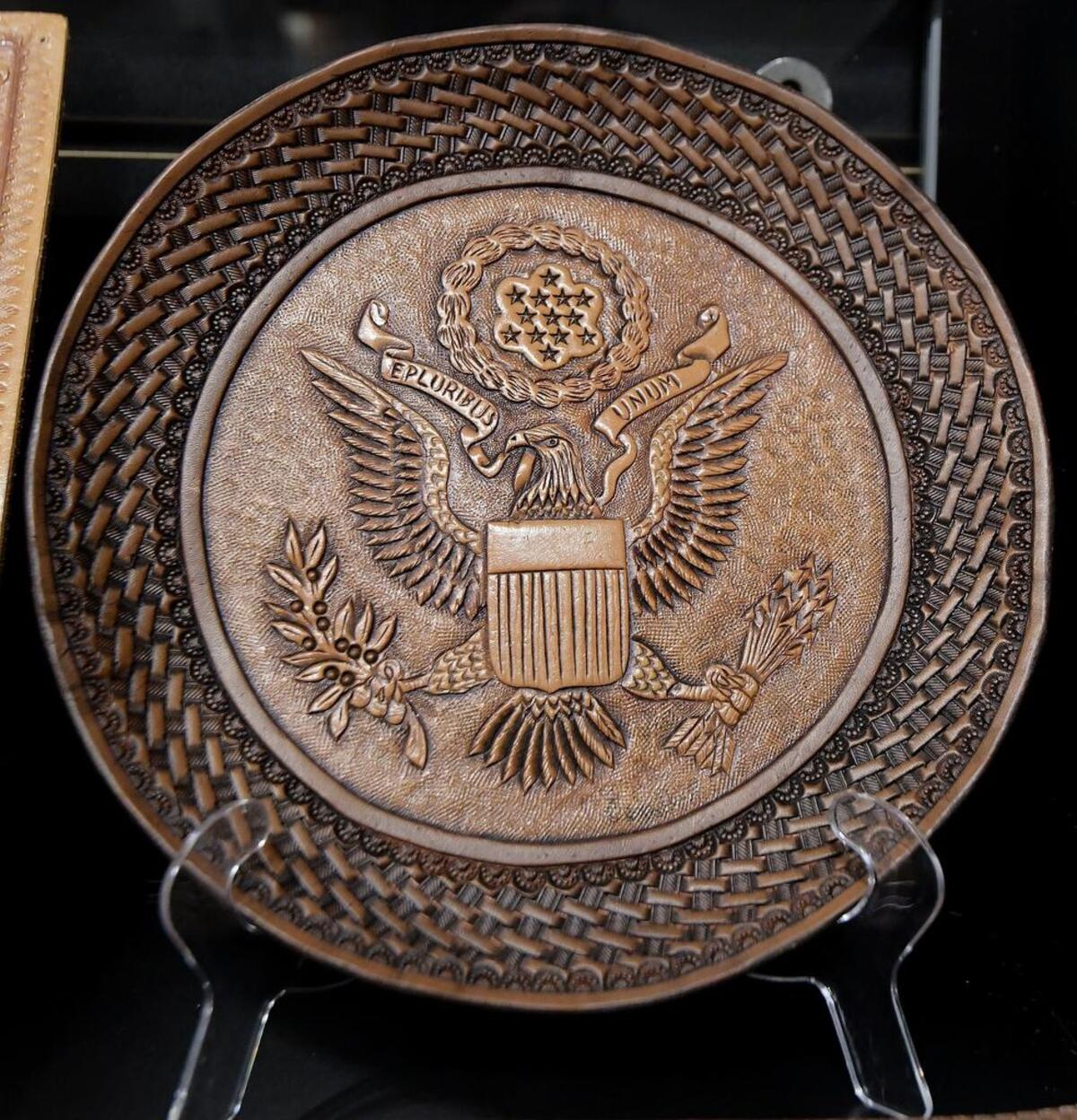 A leather plate featuring the Presidential seal that George Hurst created.