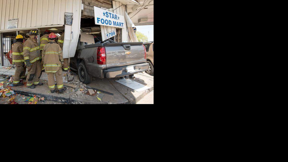 
Fort Worth firefighters work to remove victims trapped inside a store at East Lancaster Avenue on Tuesday. 
