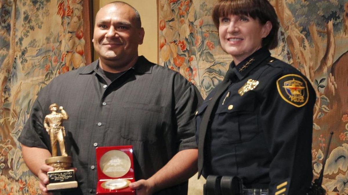 
Fort Worth police fugitive officer Mike Ruelas poses with interim police Chief Rhonda Robertson after he was named Police Officer of the Year Thursday, May 28, 2015.
