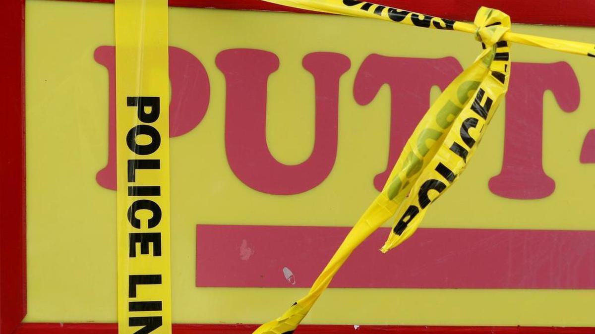 Detail photo of crime scene tape around the Putt Putt sign on Oct. 16, 2006.