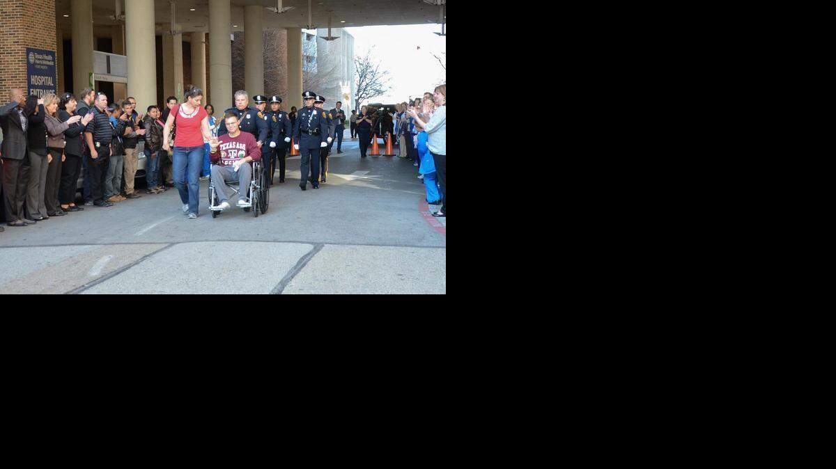 
Police Sgt. Shane Drake is wheeled out of Harris hospital Wednesday two weeks after he was shot. 
