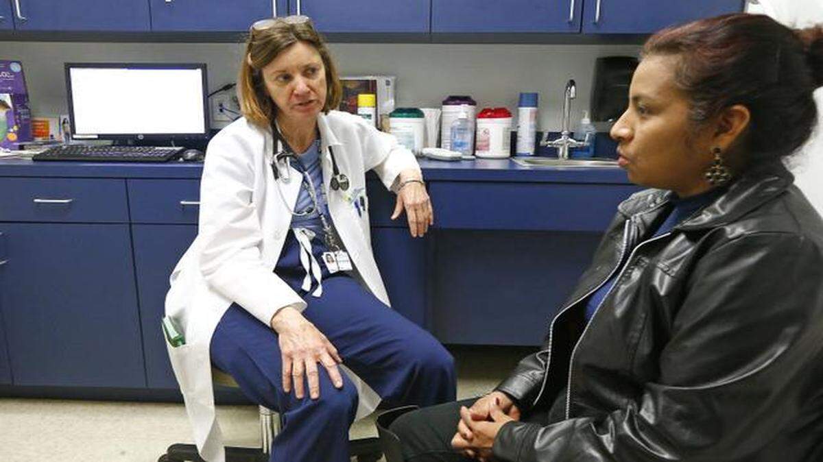 
Dr. Sharon Mulvehill, left, chief medical officer for the North Texas Community Health Centers, talks with patient Maura Rosario on Monday. The agency’s Fort Worth north-side clinic is reaching out to the community for Colon Cancer Awareness Month. 
