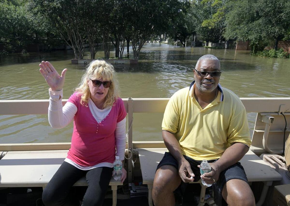 Linda Glaw and Garland Robinson were all smiles after being rescued by Grand Prairie police and members of the Texas Army National Guard in west Houston.